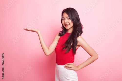 Young Asian woman present with her hand. © halfbottle