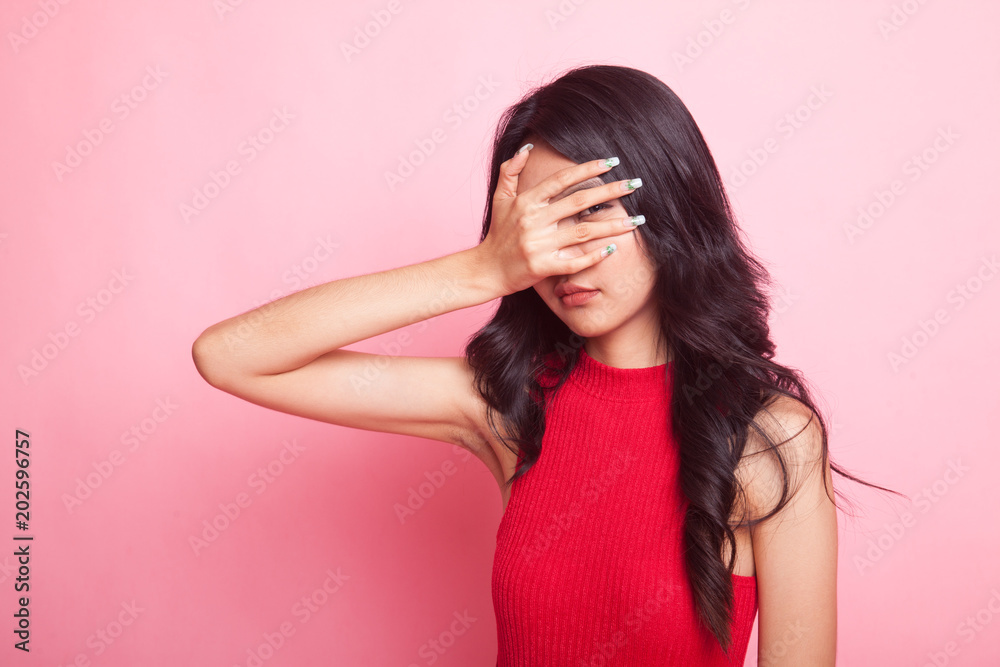 Beautiful young Asian woman peeking through fingers. Beautiful young Asian woman peeking through fingers.