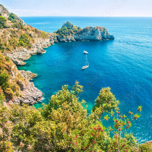 small bay with boats in Aegean sea surrounded by rocks