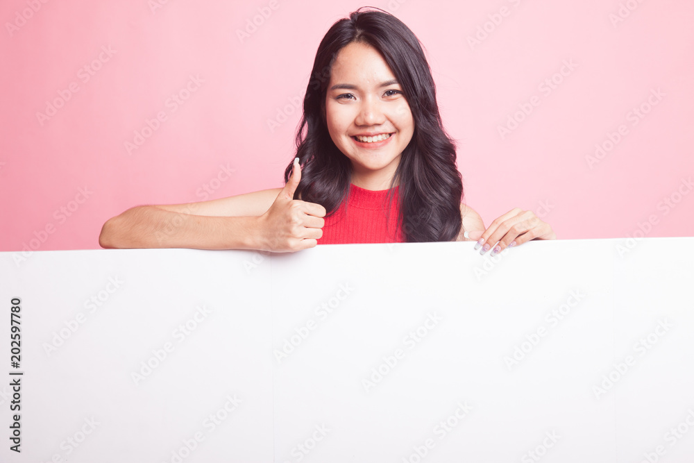 Young Asian woman show thumbs up with blank sign. Young Asian woman show thumbs up with blank sign.