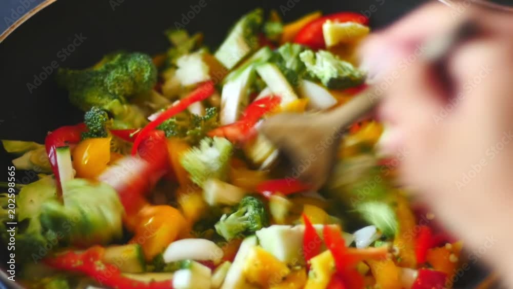 Cooking a stir fry with some spicy and tasty vegetables. 4k video
