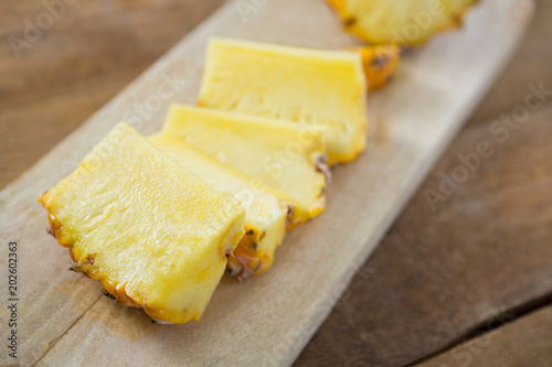 Slices of pineapple kept on chopping board