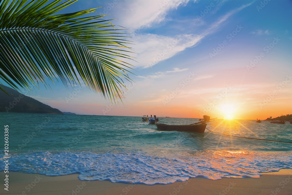 Sunrise with long tale boat on colorful sea beach and blue sky at Lipe Island Thailand , beautiful beach, summer concept, sea and sand, traveling,wave Sunrise with long tale boat on colorful sea beach and blue sky at Lipe Island Thailand , beautiful beach, summer concept, sea and sand, traveling,wave