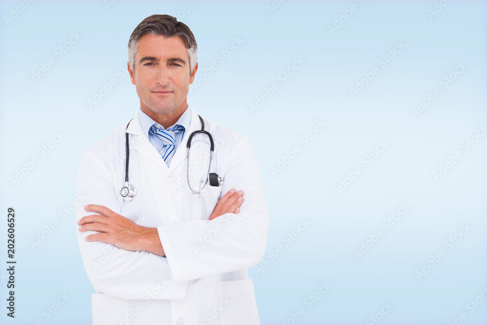 Serious doctor looking at camera against blue vignette background Serious doctor looking at camera against blue vignette background