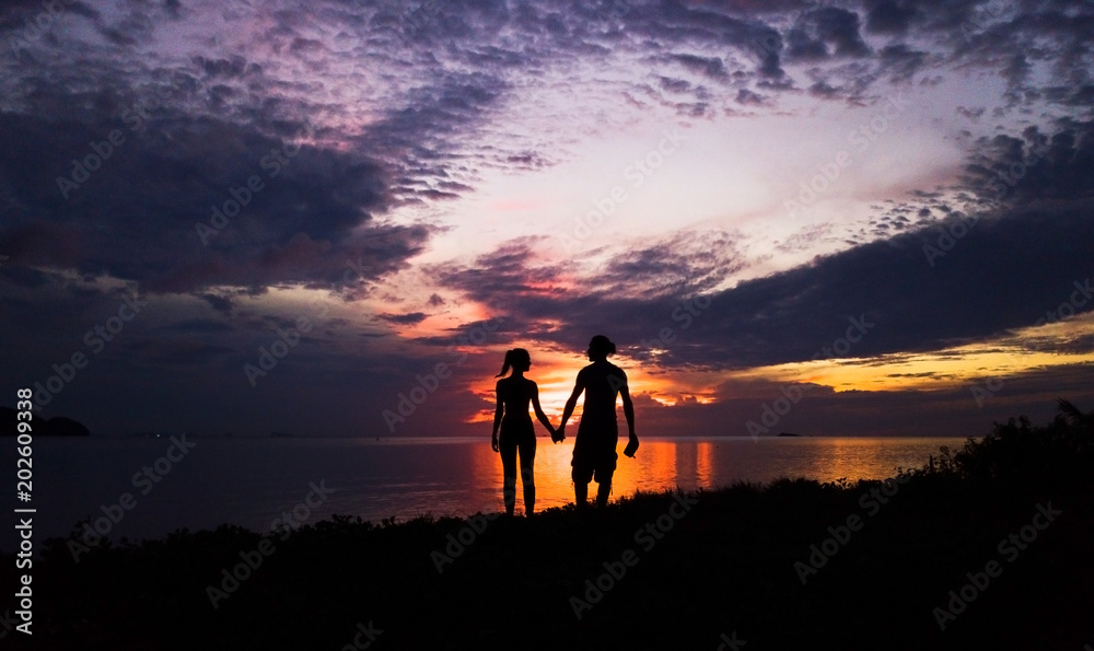 Couple in love silhouette during sea sunset