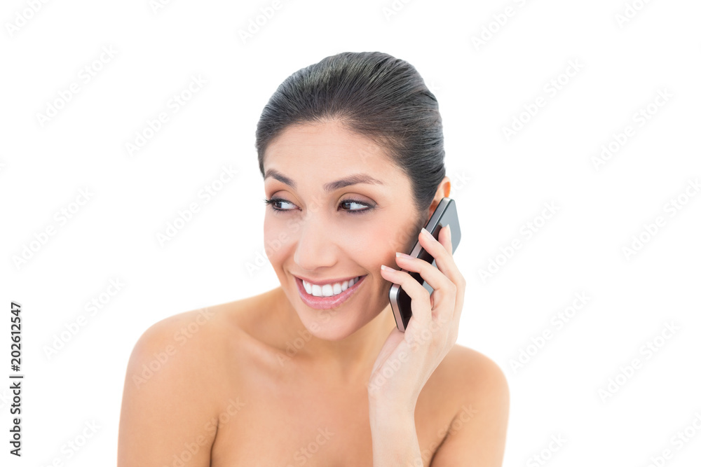 Attractive brunette making a call on smartphone Attractive brunette making a call on smartphone