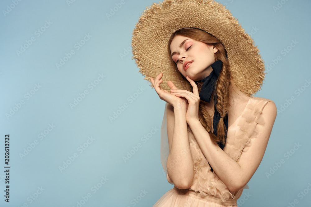 woman in a straw hat tilted her head to the side