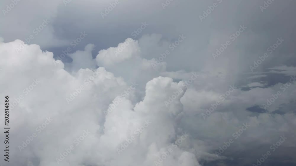 4K Traveling by air. Wonderful view of the sky and clouds from above, as seen through an airplane window. Plane in flight trip and beautiful views from the perspective of the traveler in the cabin-Dan 4K Traveling by air. Wonderful view of the sky and clouds from above, as seen through an airplane window. Plane in flight trip and beautiful views from the perspective of the traveler in the cabin-Dan