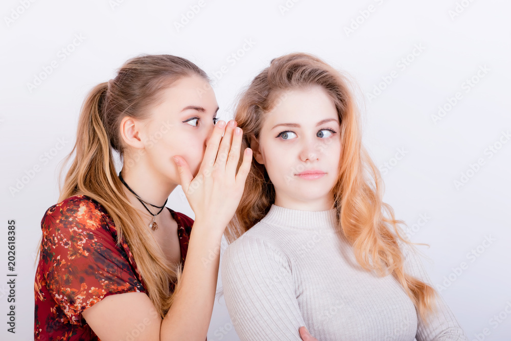 Two beautiful young girls share gossip Two beautiful young girls share gossip