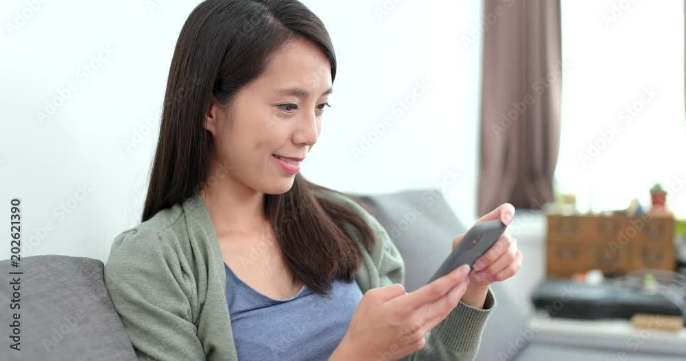 Woman look at mobile phone at home Woman look at mobile phone at home