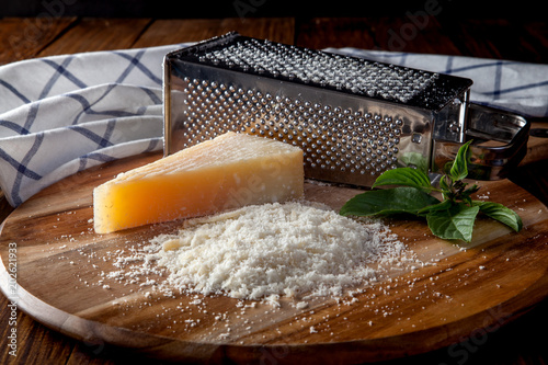 Freshly grated parmesan cheese on wooden 