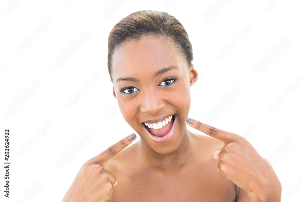 Smiling natural beauty pointing at her smile Smiling natural beauty pointing at her smile