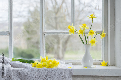 Fototapeta Naklejka Na Ścianę i Meble -  yellow spring flowers on windowsill