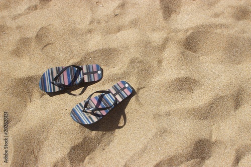 Flip flops on a sandy beach