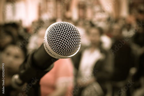 Seminar Conference Concept : Close-up Microphones on abstract blurred of speech in meeting room, front speaking blur people in event convention hall in hotel background