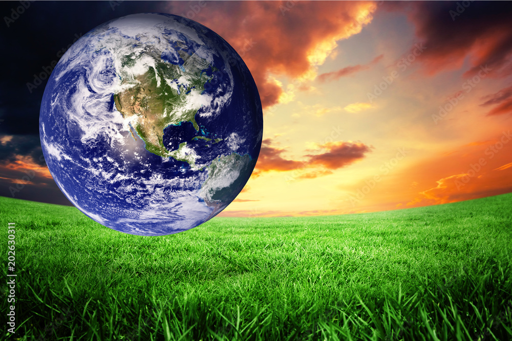 earth against green field under orange sky earth against green field under orange sky