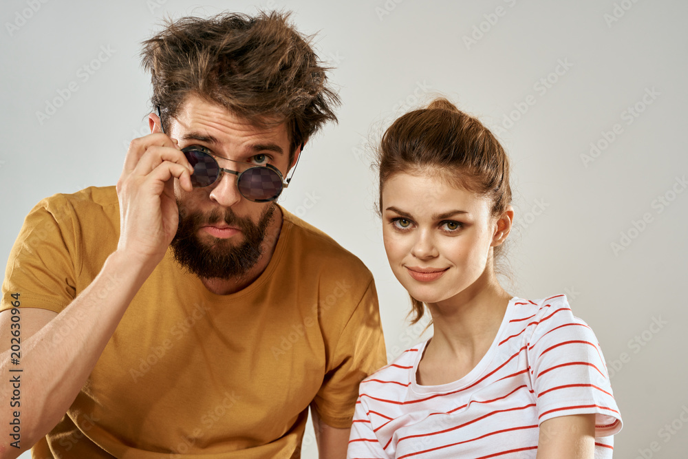 elegant man in glasses and a woman in a striped shirt elegant man in glasses and a woman in a striped shirt