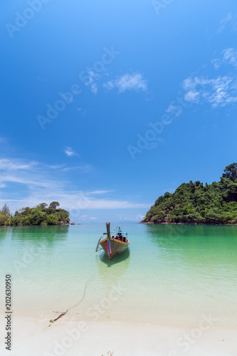White sand beach and Long-tail boat at Kham-Tok Island (koh-kam-tok), The beautiful sea Ranong Province, Thailand. © PRASERT