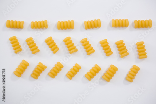 Riccioli pasta arranged on white background