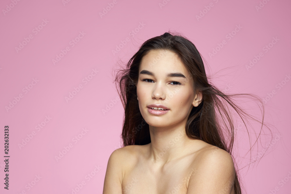woman with flowing hair on a pink background woman with flowing hair on a pink background