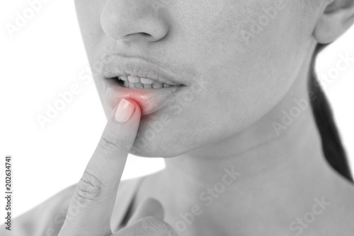 Woman pointing her lip on white background