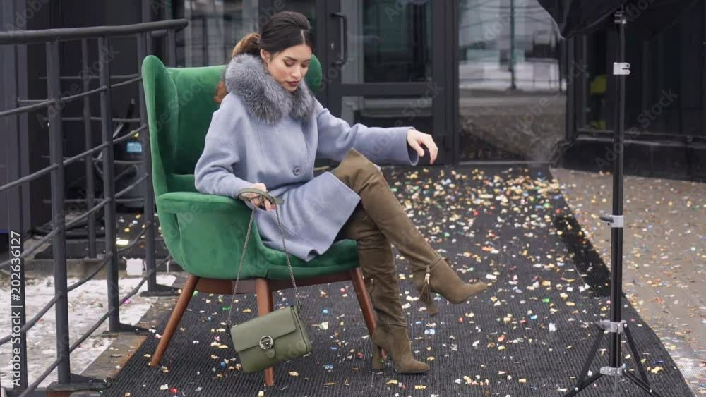 Street photo shoot of a girl in a coat. Photoshoot for the catalog of a