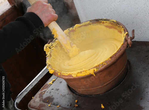 cook during the preparation of POLENTA a typical dish with boile