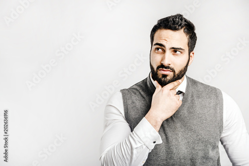 Portrait of happy bearded eastern thinking businessman on isolated white background photo