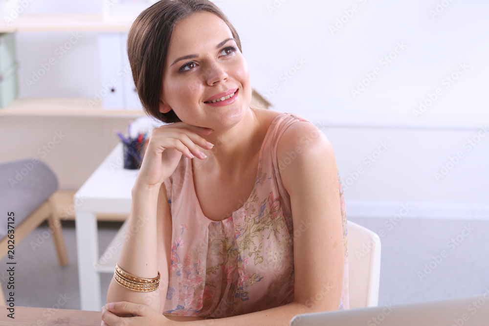 Beautiful young business woman sitting at office desk and talking on cell phone. Business woman Beautiful young business woman sitting at office desk and talking on cell phone. Business woman