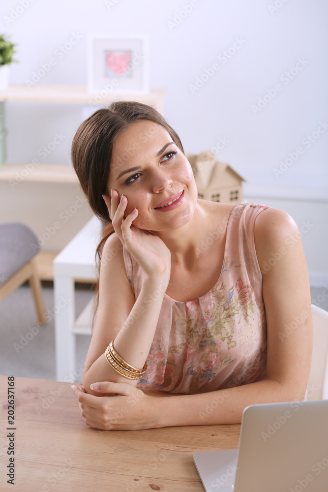 Beautiful young business woman sitting at office desk and talking on cell phone. Business woman Beautiful young business woman sitting at office desk and talking on cell phone. Business woman