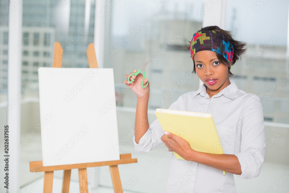 Attractive artistic woman holding sketchpad and scissors Attractive artistic woman holding sketchpad and scissors