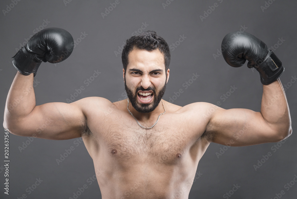 Handsome boxer man win the fight, winner concept on isolated grey background