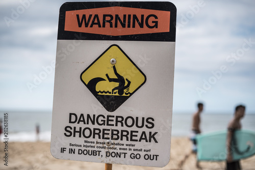 A dangerous shorebreak sign at the beach in the north shore of Oahu, Hawaii