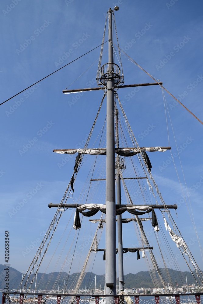 Mast sailing ship against a blue sky Mast sailing ship against a blue sky