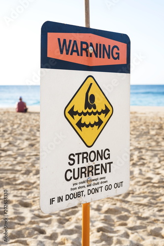 A Warning Strong Current sign at the beach in the north shore of Oahu, Hawaii