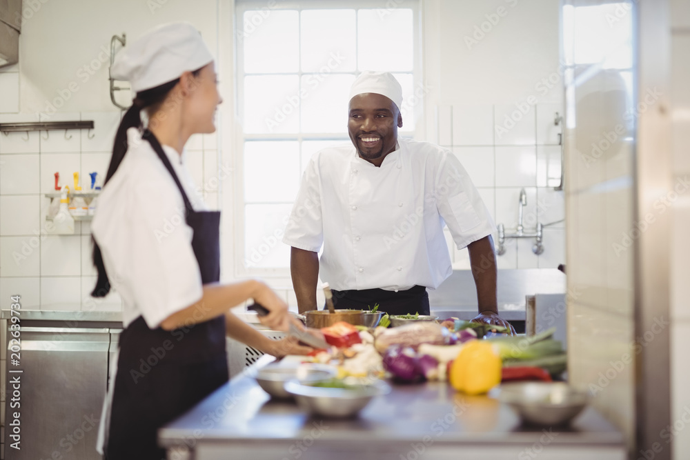 Chefs chopping vegetables in the commercial kitchen Chefs chopping vegetables in the commercial kitchen