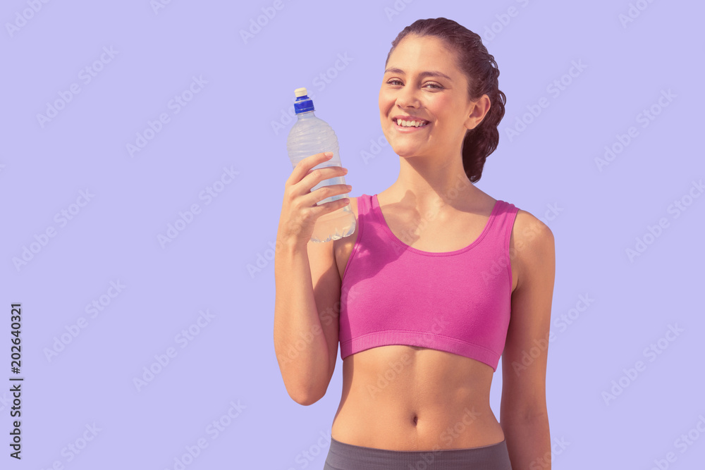 Fit woman with water against purple background Fit woman with water against purple background
