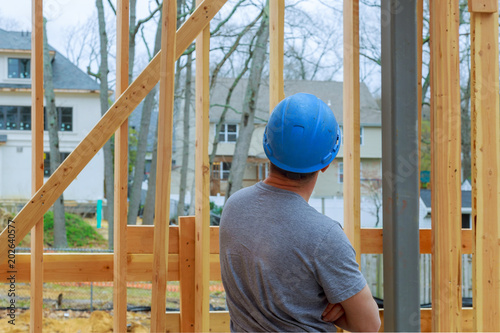 Construction Worker Building Timber Frame New Home photo