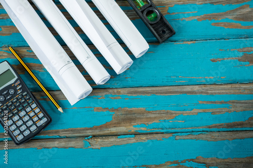 Calculator, paper scrolls, pencil and level tool  photo