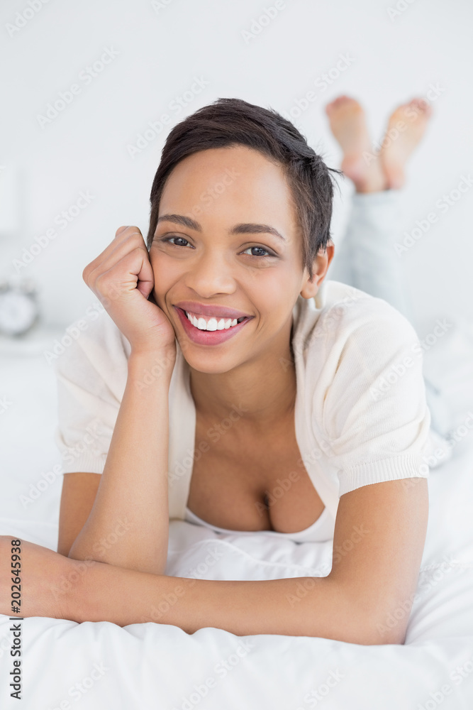 Smiling pretty young woman relaxing in bed Smiling pretty young woman relaxing in bed