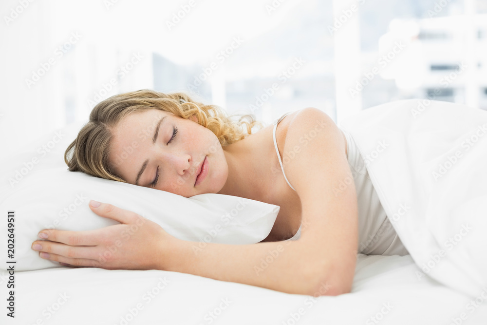 Pretty peaceful blonde lying in bed resting with closed eyes Pretty peaceful blonde lying in bed resting with closed eyes