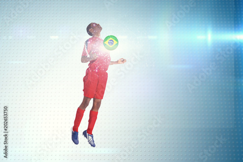 Football player in red jumping against technical screen with pixels  © vectorfusionart