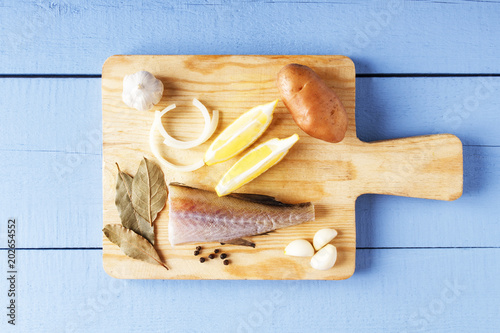 Ingredients for cooking healthy food on cutting board. Fresh organic vegetables and sea fish. Natural products closeup. Top view with copy space