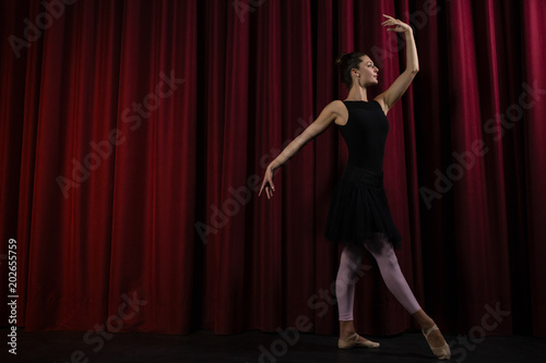 Ballerina performing ballet dance on stage © WavebreakmediaMicro