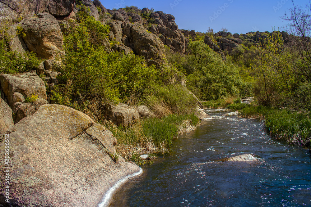 River in Aktovsky canyon, Ukraine. Big rocks in river, calm water. River in Aktovsky canyon, Ukraine. Big rocks in river, calm water.