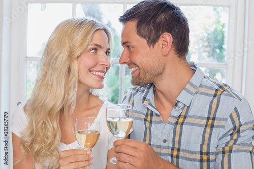 Loving couple with wine glasses looking at each other © WavebreakmediaMicro