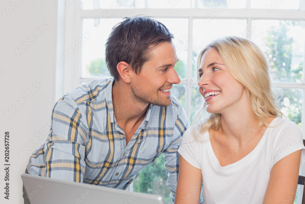 Smiling young couple looking at each other at home Smiling young couple looking at each other at home