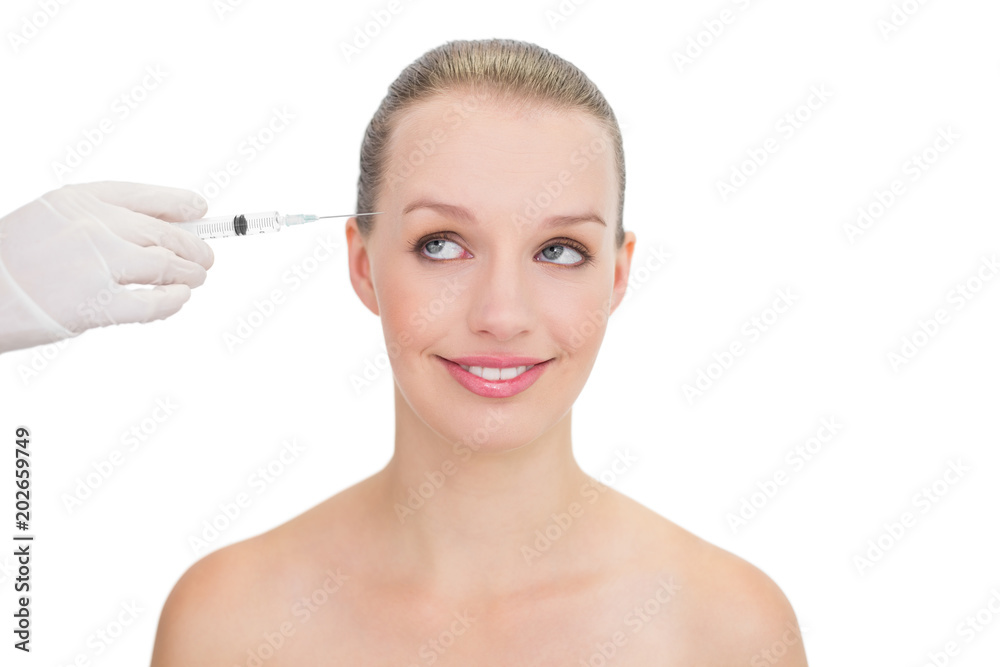 Thoughtful pretty blonde model receiving botox injection