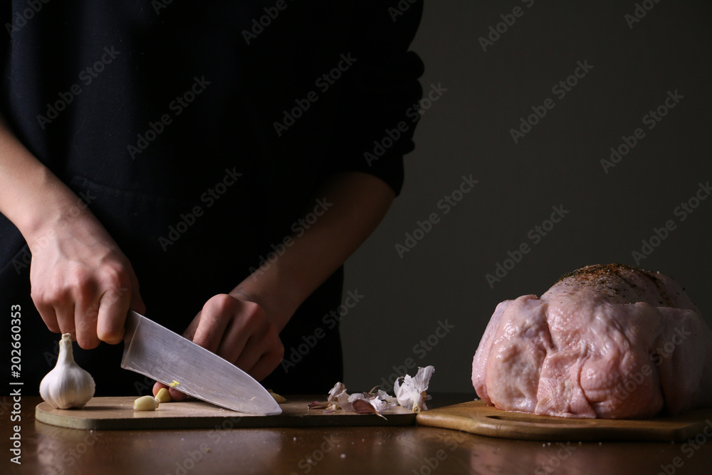 Chef hands cooking the whole chicken in the dark background. With spices. Preparing for frying .Photo with copyspace