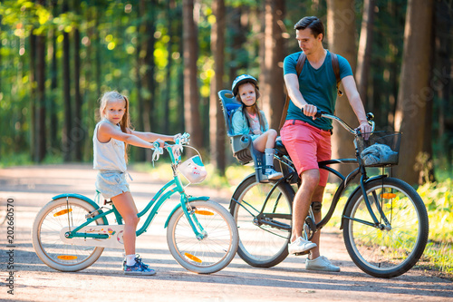 Happy family biking outdoors at the park